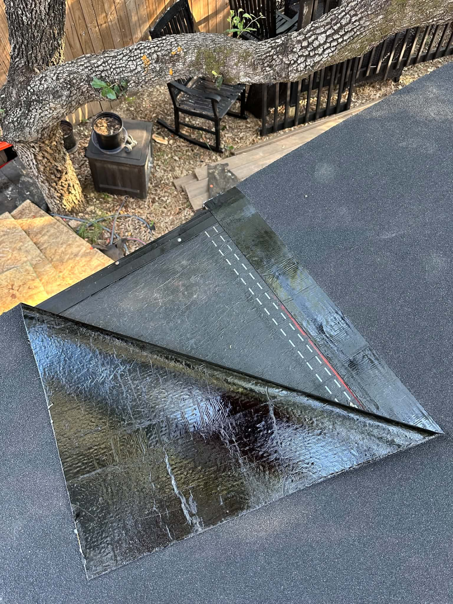 Close-up of dark roofing sheets and layers at an edge