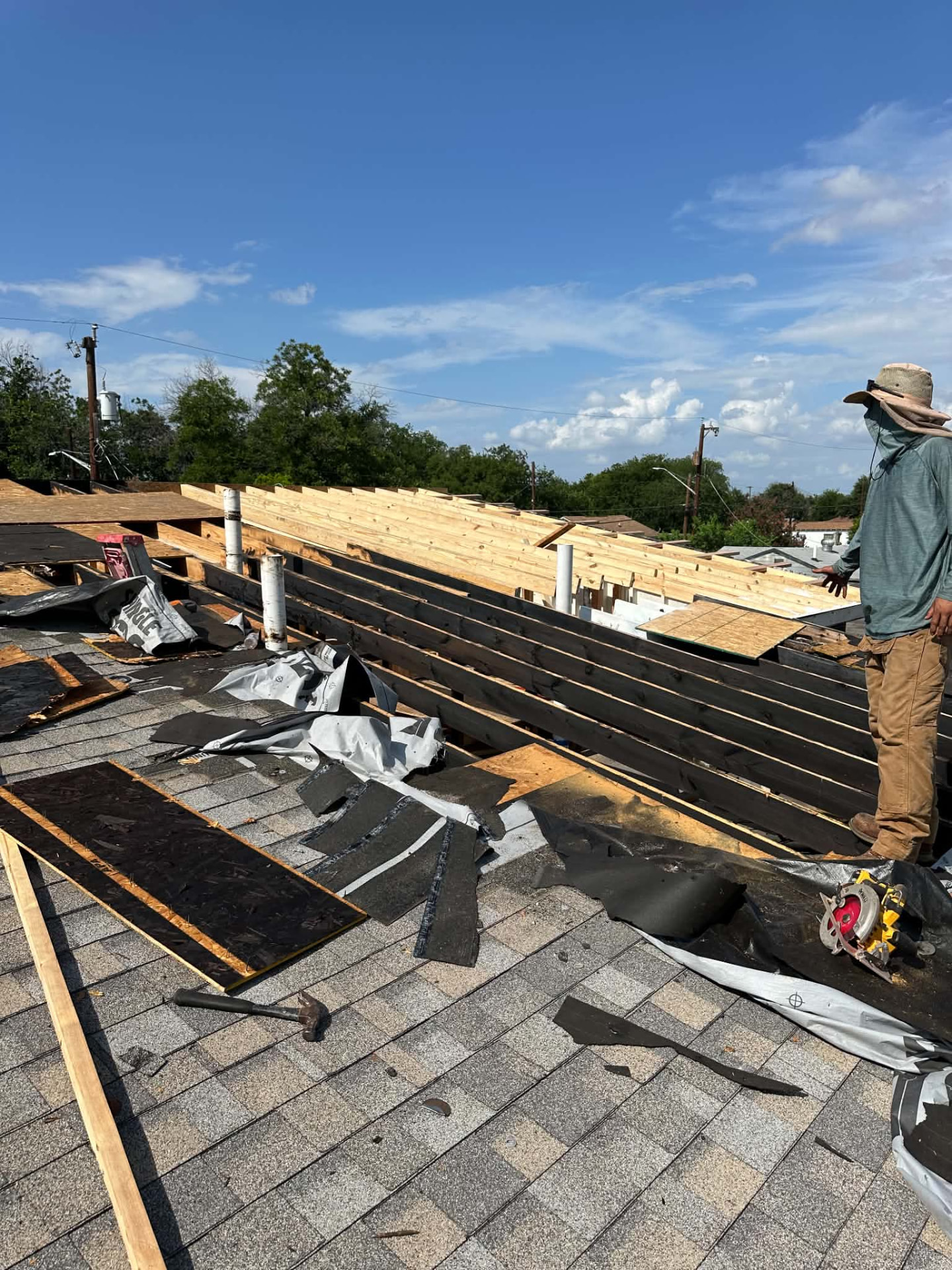 Existing shingles and roof covering being removed during a San Antonio roof replacement