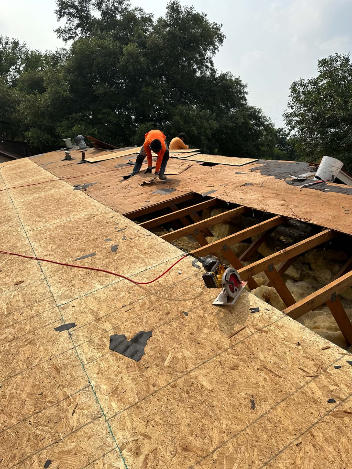 Open roof decking sections revealing framing and insulation