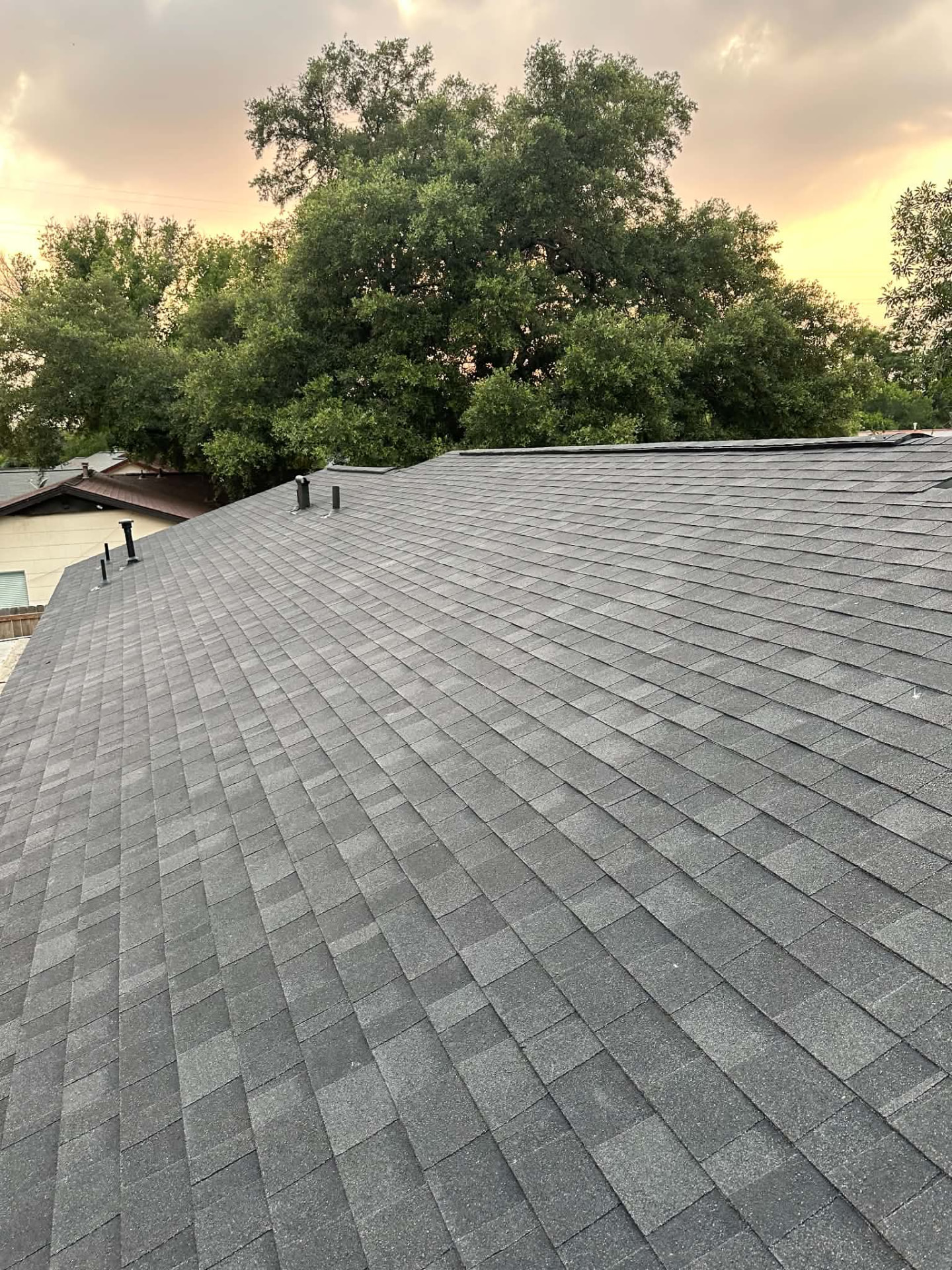 Finished gray shingle roof with roof penetrations in San Antonio